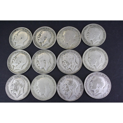 66 - A collection of twelve British King George V pre 1947 silver half crown coins.