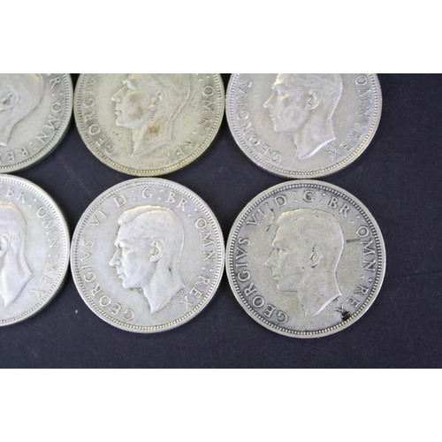 68 - A collection of twelve British King George VI pre 1947 silver half crown coins.