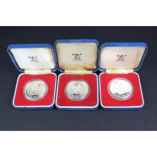 80 - A collection of three cased silver proof coins with COA's to include a Royal Mint 1977 silver proof ... 