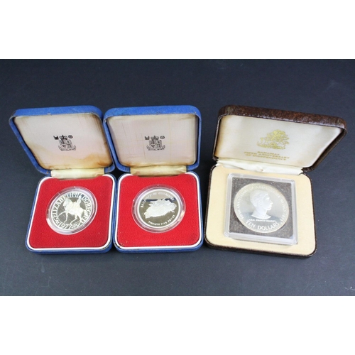 84 - A collection of three cased silver proof coins with COA's to include a Royal Mint 1977 silver proof ... 