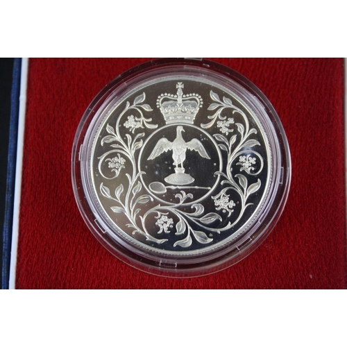 84 - A collection of three cased silver proof coins with COA's to include a Royal Mint 1977 silver proof ... 