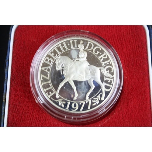 85 - A collection of three cased silver proof coins with COA's to include a Royal Mint 1977 silver proof ... 