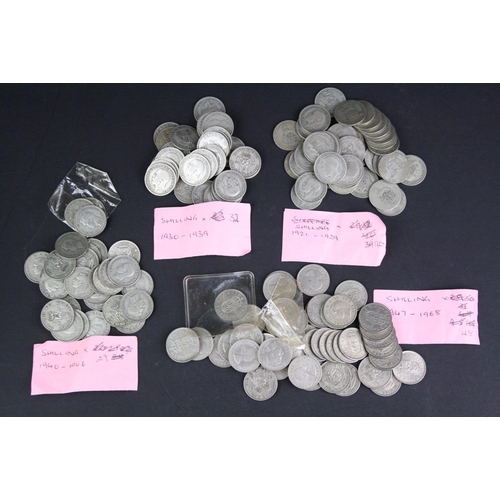 89 - A large collection of British pre decimal shilling coins to include pre 1947 silver examples.