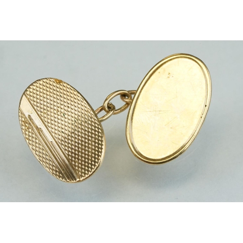 318 - Pair of 9ct yellow gold cufflinks, oval panels, plain polished and engine turned design, chain links... 