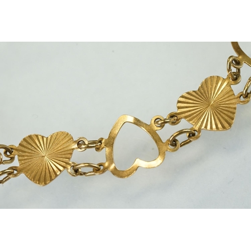 334 - 9ct yellow gold heart shaped panel bracelet, alternate openwork hearts with textured hearts, bolt ri... 