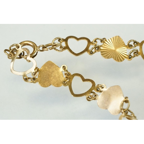 334 - 9ct yellow gold heart shaped panel bracelet, alternate openwork hearts with textured hearts, bolt ri... 