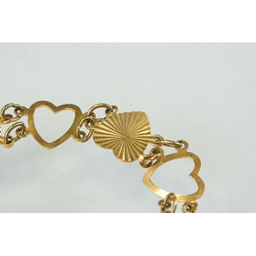 334 - 9ct yellow gold heart shaped panel bracelet, alternate openwork hearts with textured hearts, bolt ri... 