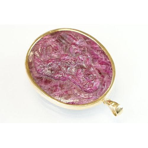 339 - Ruby 9ct yellow gold cameo pendant, the carved ruby depicting Jesus, rubover setting, length approx ... 