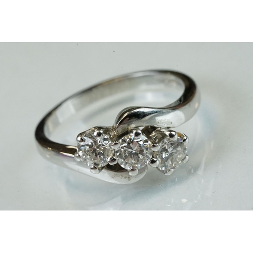 341 - Diamond 18ct white gold three stone crossover ring, three round brilliant cut diamonds, total stated... 