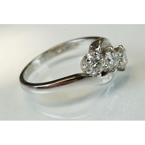 341 - Diamond 18ct white gold three stone crossover ring, three round brilliant cut diamonds, total stated... 