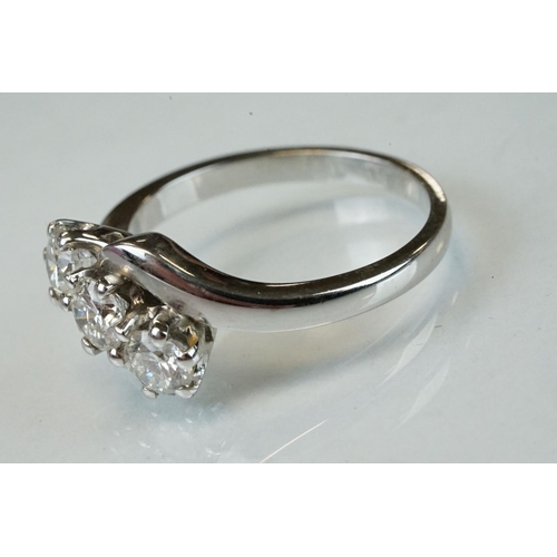 341 - Diamond 18ct white gold three stone crossover ring, three round brilliant cut diamonds, total stated... 