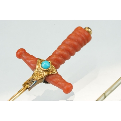 348 - Late 19th century coral, turquoise and split pearl unmarked gold stick pin modelled as a sword hilt,... 