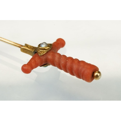 348 - Late 19th century coral, turquoise and split pearl unmarked gold stick pin modelled as a sword hilt,... 