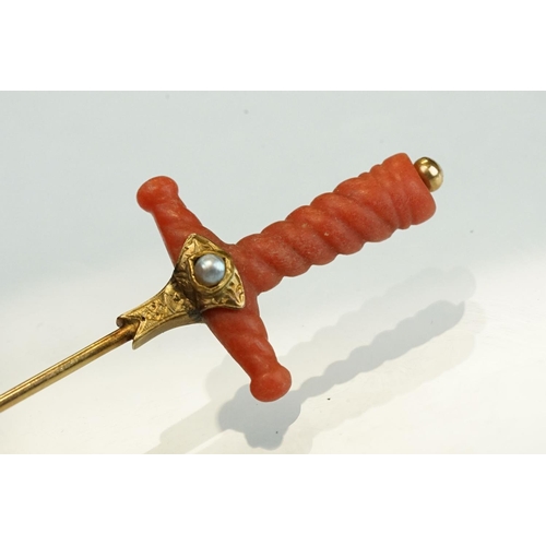 348 - Late 19th century coral, turquoise and split pearl unmarked gold stick pin modelled as a sword hilt,... 