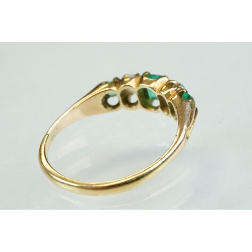 42 - 19th century emerald and diamond unmarked yellow gold ring, possibly stamped 18ct, three graduated e... 