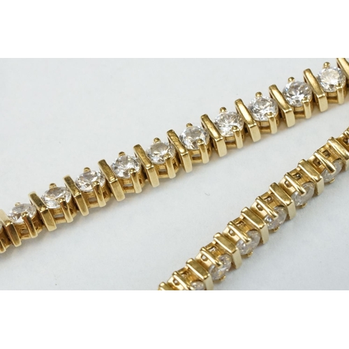 43 - Cubic zirconia 18ct yellow gold tennis bracelet, forty-seven round brilliant cut cubic zirconia, cla... 