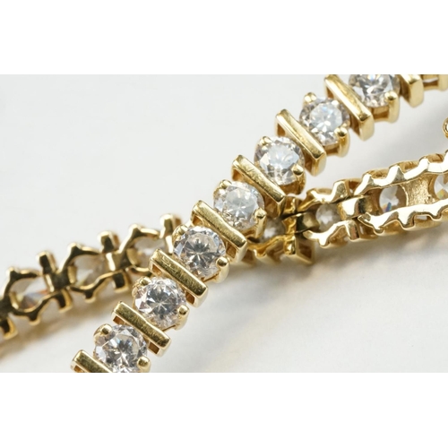 43 - Cubic zirconia 18ct yellow gold tennis bracelet, forty-seven round brilliant cut cubic zirconia, cla... 