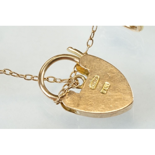 47 - 9ct yellow gold gate link bracelet, heart shaped padlock clasp with foliate scroll decoration, the l... 