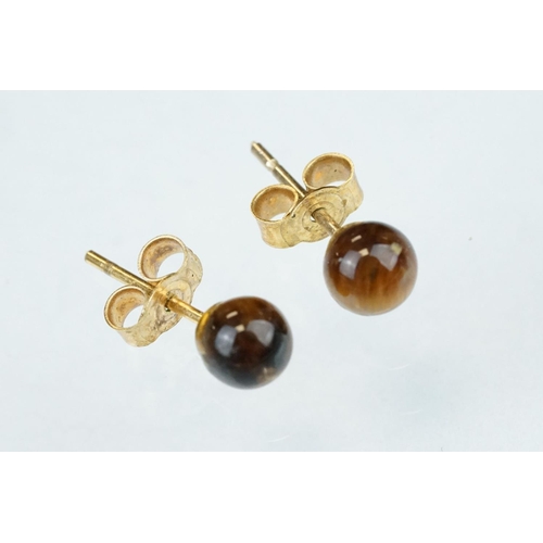 122 - Pair of tigers eye 9ct yellow gold stud earrings; and three further pairs of 9ct yellow gold and yel... 