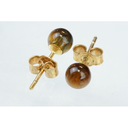 122 - Pair of tigers eye 9ct yellow gold stud earrings; and three further pairs of 9ct yellow gold and yel... 