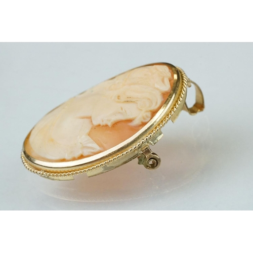 124 - Shell cameo 9ct yellow gold brooch depicting the Three Graces, rubover set, rope twist surround; tog... 