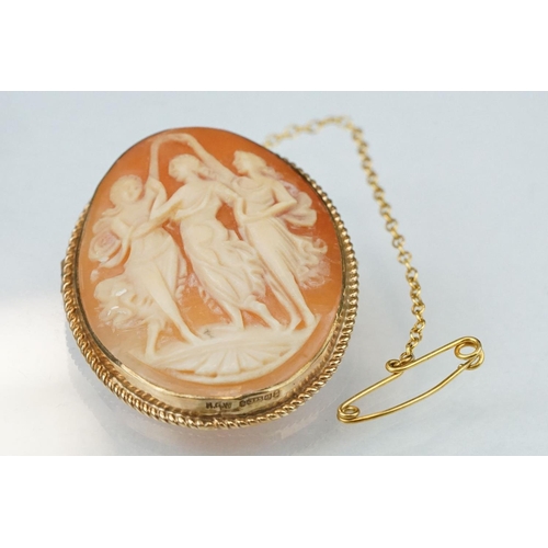 124 - Shell cameo 9ct yellow gold brooch depicting the Three Graces, rubover set, rope twist surround; tog... 