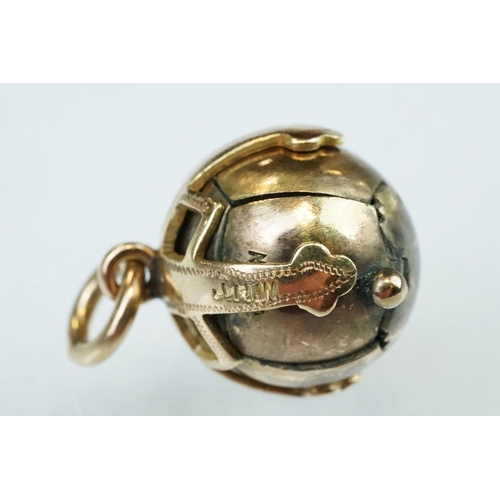 124A - Yellow metal masonic orb pendant opening to reveal a cross formed from pyramids bearing masonic symb... 