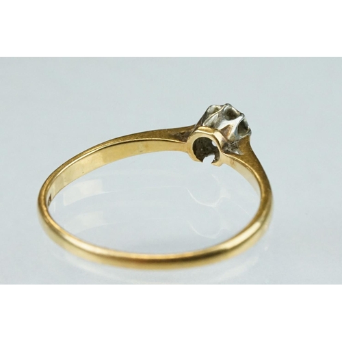 148 - Diamond solitaire 18ct yellow gold platinum set ring, the round old cut diamond weighing approx 0.07... 