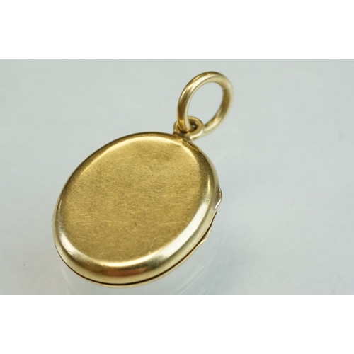 187 - Yellow metal oval locket, plain polished exterior, the interior engraved Emily, length approx 2cm, w... 