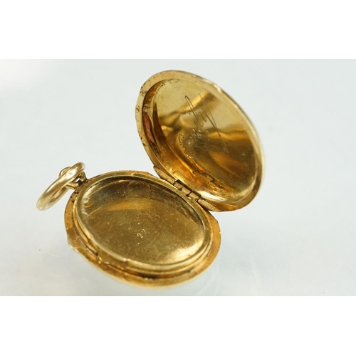 187 - Yellow metal oval locket, plain polished exterior, the interior engraved Emily, length approx 2cm, w... 