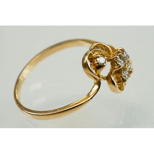 192 - Diamond yellow metal ring, four small round brilliant cut diamonds, total diamond weight approx 0.20... 