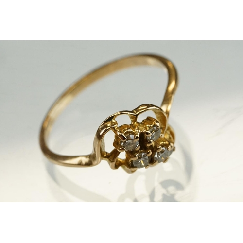 192 - Diamond yellow metal ring, four small round brilliant cut diamonds, total diamond weight approx 0.20... 