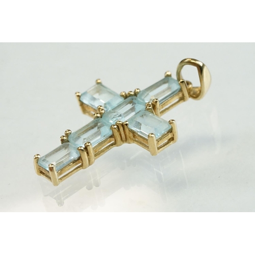 198 - Topaz 9ct yellow gold cross pendant, six rectangular mixed cut blue topaz, claw set, length approx 2... 