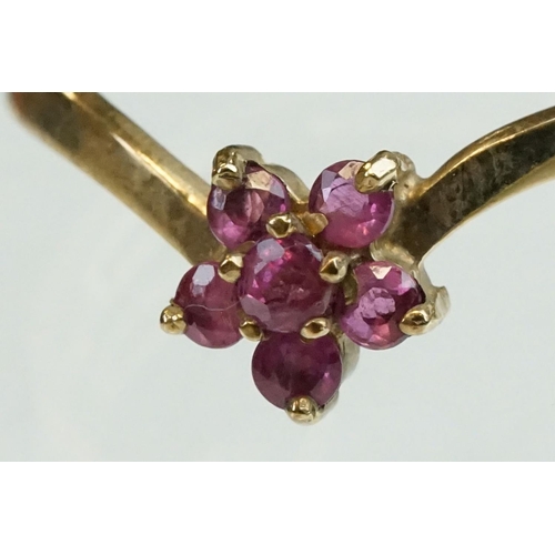 200 - Ruby and diamond 9ct yellow gold ring, crossover style, three graduated round mixed cut rubies, one ... 