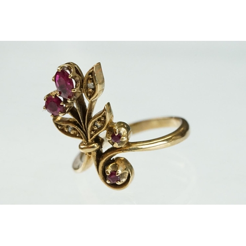 200 - Ruby and diamond 9ct yellow gold ring, crossover style, three graduated round mixed cut rubies, one ... 