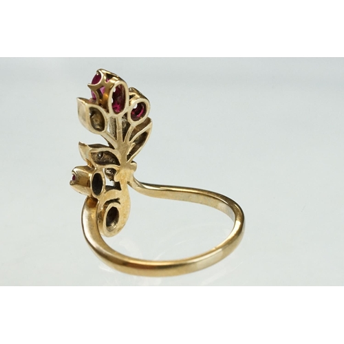 200 - Ruby and diamond 9ct yellow gold ring, crossover style, three graduated round mixed cut rubies, one ... 