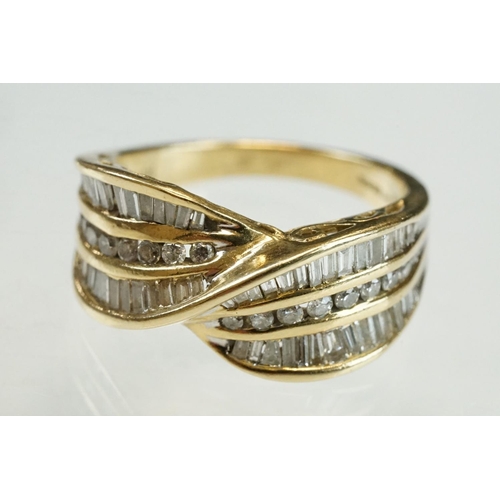 203 - Diamond 14ct yellow gold crossover ring, eighteen small round brilliant cut diamonds with two rows o... 