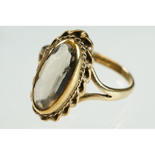 204 - Smoky quartz 9ct yellow gold ring, the oval mixed cut smoky quartz measuring approx 14mm x 6mm, rubo... 