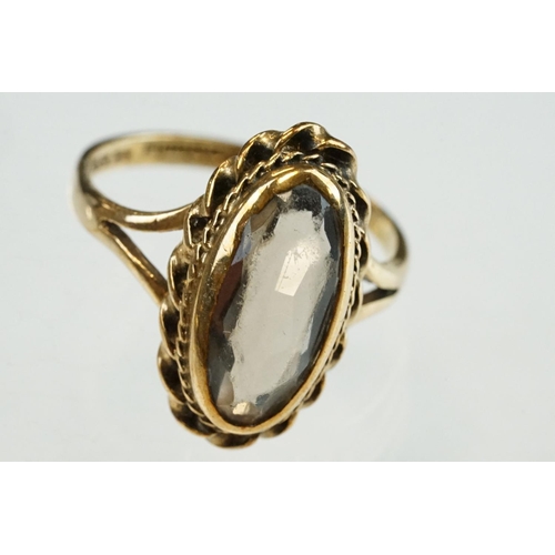 204 - Smoky quartz 9ct yellow gold ring, the oval mixed cut smoky quartz measuring approx 14mm x 6mm, rubo... 