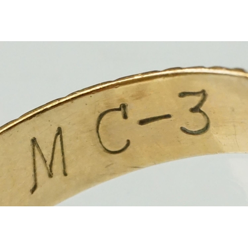 207 - 9ct yellow gold wedding band, engraved and bright cut decoration, the interior engraved MC-3, width ... 