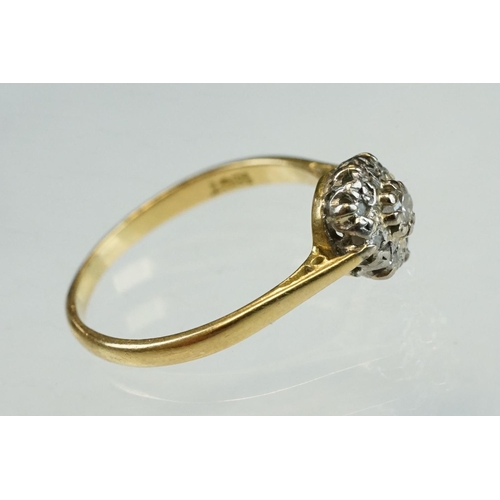 211 - Diamond 18ct yellow and white gold set cluster ring, the central small round brilliant cut diamond w... 