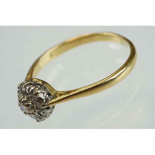 211 - Diamond 18ct yellow and white gold set cluster ring, the central small round brilliant cut diamond w... 