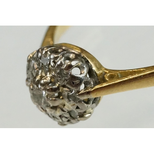 211 - Diamond 18ct yellow and white gold set cluster ring, the central small round brilliant cut diamond w... 