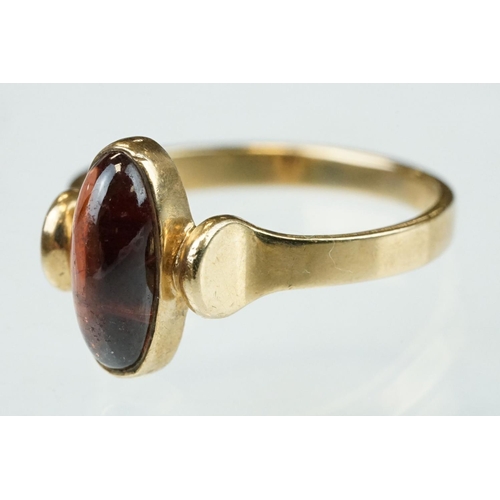 216 - Garnet 9ct yellow gold ring, oval cabochon cut garnet measuring approx 11.5mm x 5mm, rubover set, st... 