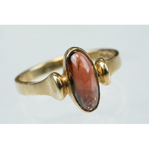 216 - Garnet 9ct yellow gold ring, oval cabochon cut garnet measuring approx 11.5mm x 5mm, rubover set, st... 