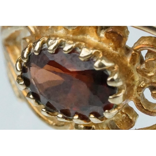 218 - Garnet 9ct yellow gold ring, the oval mixed cut garnet measuring approx 3.5mm x 6mm, claw set, pierc... 