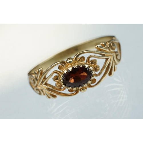 218 - Garnet 9ct yellow gold ring, the oval mixed cut garnet measuring approx 3.5mm x 6mm, claw set, pierc... 