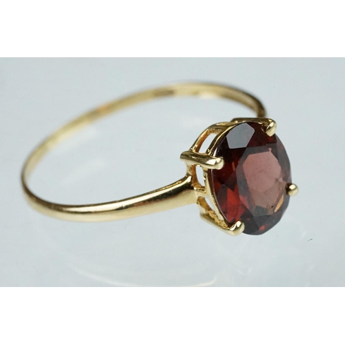 222 - Garnet 9ct yellow gold ring, the oval mixed cut garnet measuring approx 9.5mm x 7.5mm, claw set, rin... 