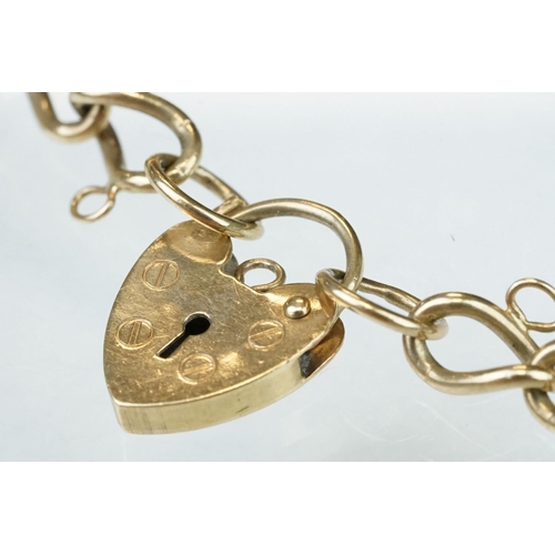 227 - 9ct yellow gold curb link bracelet, heart shaped padlock clasp