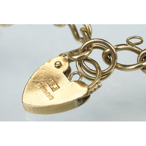 227 - 9ct yellow gold curb link bracelet, heart shaped padlock clasp